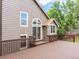 Exterior featuring a large deck, brown siding, and sliding glass doors at 9016 W Alabama Pl, Lakewood, CO 80232