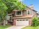 Charming two-story house with a brick facade, a two-car garage, and a well-maintained front yard at 9016 W Alabama Pl, Lakewood, CO 80232