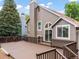 Exterior featuring a large deck, brown siding, and sliding glass doors at 9016 W Alabama Pl, Lakewood, CO 80232