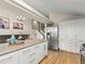 Modern kitchen boasts stainless steel appliances, light countertops and an island, perfect for cooking and entertaining at 9016 W Alabama Pl, Lakewood, CO 80232