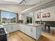 Bright kitchen features white cabinets, a large island, stainless steel appliances, and plenty of natural light at 9016 W Alabama Pl, Lakewood, CO 80232