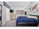 A comfortable bedroom featuring plush carpeting, a modern TV, and a stylish world map decoration at 2003 S Helena St # D, Aurora, CO 80013