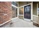 Exterior doorway view, brick chimney and walkway leading into the home at 2003 S Helena St # D, Aurora, CO 80013