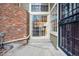 Exterior doorway view, brick chimney and walkway leading into the home at 2003 S Helena St # D, Aurora, CO 80013