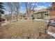 Street view of multi-Gathering home with a well-maintained lawn, mature trees, and manicured landscaping at 2003 S Helena St # D, Aurora, CO 80013