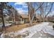 Charming two-story home with manicured front lawn, mature trees, and inviting entrance during the winter at 2003 S Helena St # D, Aurora, CO 80013