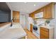 Well-lit kitchen features light wood cabinets, white appliances, and laminate countertops at 2003 S Helena St # D, Aurora, CO 80013
