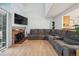 Comfortable living room features a brick fireplace, large windows and a sectional sofa at 2003 S Helena St # D, Aurora, CO 80013