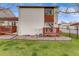 The backyard shows a well-maintained patio with wood railing, rock landscaping, and green grass at 1236 Sequerra St, Broomfield, CO 80020