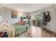 Bright bedroom featuring hardwood floors and sliding glass doors to private balcony at 1236 Sequerra St, Broomfield, CO 80020