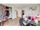 Bright bedroom with light wood floors, a window, and an open closet with shelving at 1236 Sequerra St, Broomfield, CO 80020