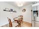 Bright dining area features a round table, stainless steel refrigerator, and decor at 1236 Sequerra St, Broomfield, CO 80020