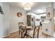 Charming dining area with a chandelier, white cabinetry, and stainless steel appliances at 1236 Sequerra St, Broomfield, CO 80020