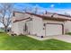 Charming home exterior featuring a gated courtyard, red tile roof, white stucco, and a one-car garage at 1236 Sequerra St, Broomfield, CO 80020