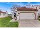 Home exterior featuring a tile roof, two-car garage and xeriscaped front yard at 1236 Sequerra St, Broomfield, CO 80020