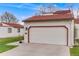 Attached one car garage with white door and red roof in a home with a well-manicured lawn at 1236 Sequerra St, Broomfield, CO 80020