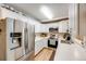 Modern kitchen featuring white cabinets, stainless steel appliances, and beautiful countertops at 1236 Sequerra St, Broomfield, CO 80020
