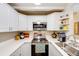 Well-equipped kitchen with stainless steel appliances, white cabinets and plenty of storage at 1236 Sequerra St, Broomfield, CO 80020