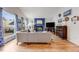 Bright living room features a brick fireplace, wood floors, and large windows with backyard view at 1236 Sequerra St, Broomfield, CO 80020