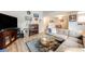 Inviting living room with a modern sectional sofa, hardwood floors, and ample natural light at 1236 Sequerra St, Broomfield, CO 80020