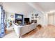 Bright living room featuring a blue fireplace, modern furniture, and wood flooring at 1236 Sequerra St, Broomfield, CO 80020