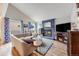 Bright living room features a blue fireplace and mantle and a comfortable L-shaped couch and accent rug at 1236 Sequerra St, Broomfield, CO 80020