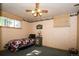 Bedroom with a single bed with a patterned blanket, window and a ceiling fan at 7684 Beverly Blvd, Castle Pines, CO 80108