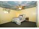 Bright bedroom with a decorative, painted sky ceiling and light, patterned bedding at 7684 Beverly Blvd, Castle Pines, CO 80108