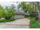 A detached one car garage with a long concrete driveway and landscaping at 7684 Beverly Blvd, Castle Pines, CO 80108
