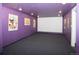 Spacious home theater with a projector screen and fun movie posters, creating an immersive viewing experience at 7684 Beverly Blvd, Castle Pines, CO 80108