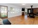 Spacious living room featuring hardwood floors, a fireplace, and plenty of natural light from large windows at 7684 Beverly Blvd, Castle Pines, CO 80108