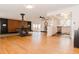 Spacious living room with hardwood floors, wood-burning stove, and an open floor plan to the kitchen at 7684 Beverly Blvd, Castle Pines, CO 80108