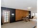Stylish living area boasts a wood-paneled wall, comfortable seating, and natural light at 7684 Beverly Blvd, Castle Pines, CO 80108