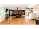 Expansive living area features a wood-burning stove, hardwood floors, and seamlessly connects to the kitchen at 7684 Beverly Blvd, Castle Pines, CO 80108