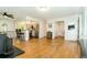 Open-concept living space with hardwood floors, a kitchen view, and a convenient bar seating area at 7684 Beverly Blvd, Castle Pines, CO 80108