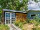 A charming outbuilding with a unique design, featuring glass doors and a rustic wooden exterior at 7684 Beverly Blvd, Castle Pines, CO 80108