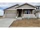 Charming single-Gathering home features a cozy front porch, stone accents, and an attached two-car garage at 25253 E Warren Pl, Aurora, CO 80018
