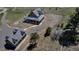 Aerial view of a house and garage on a large lot, with a winding driveway and natural landscaping at 8191 S Homesteader Dr, Morrison, CO 80465