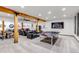 Finished basement featuring a ping pong table, lounge area, and automotive decor for a unique entertainment space at 8191 S Homesteader Dr, Morrison, CO 80465