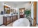 Bathroom featuring soaking tub, double vanity, and natural wood accents at 8191 S Homesteader Dr, Morrison, CO 80465