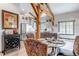 Dining area and kitchen featuring natural wood beams, views of dining area, kitchen and wine bar at 8191 S Homesteader Dr, Morrison, CO 80465