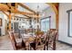 Dining room and kitchen with exposed wood beams and hardwood floors at 8191 S Homesteader Dr, Morrison, CO 80465