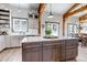 Kitchen island featuring drawers and cabinets and natural wood beams and light fixtures at 8191 S Homesteader Dr, Morrison, CO 80465