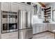 Modern kitchen with stainless steel appliances, including a double oven and refrigerator, offers lots of cooking space at 8191 S Homesteader Dr, Morrison, CO 80465