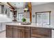 Spacious kitchen with white cabinets, quartz countertops, a central island, and natural lighting for cooking and dining at 8191 S Homesteader Dr, Morrison, CO 80465