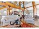 Open-concept living room with wood beams and comfortable white sofas at 8191 S Homesteader Dr, Morrison, CO 80465