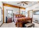Comfortable bedroom featuring ceiling fan and wood accents at 8191 S Homesteader Dr, Morrison, CO 80465