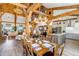 Expansive open floor plan with kitchen, dining, and living areas, highlighted by wood beams and natural light at 8191 S Homesteader Dr, Morrison, CO 80465