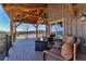 Covered porch with a cozy fire pit and comfortable seating provides an inviting spot for outdoor entertainment at 8191 S Homesteader Dr, Morrison, CO 80465
