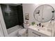 Stylish bathroom featuring black subway tile in the shower, a modern vanity, and a round mirror at 12506 E Cornell Ave # 201, Aurora, CO 80014